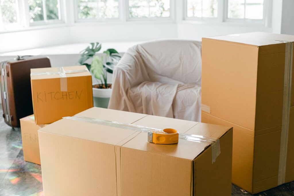 Packed moving boxes in an empty Miami apartment ready for move-out cleaning